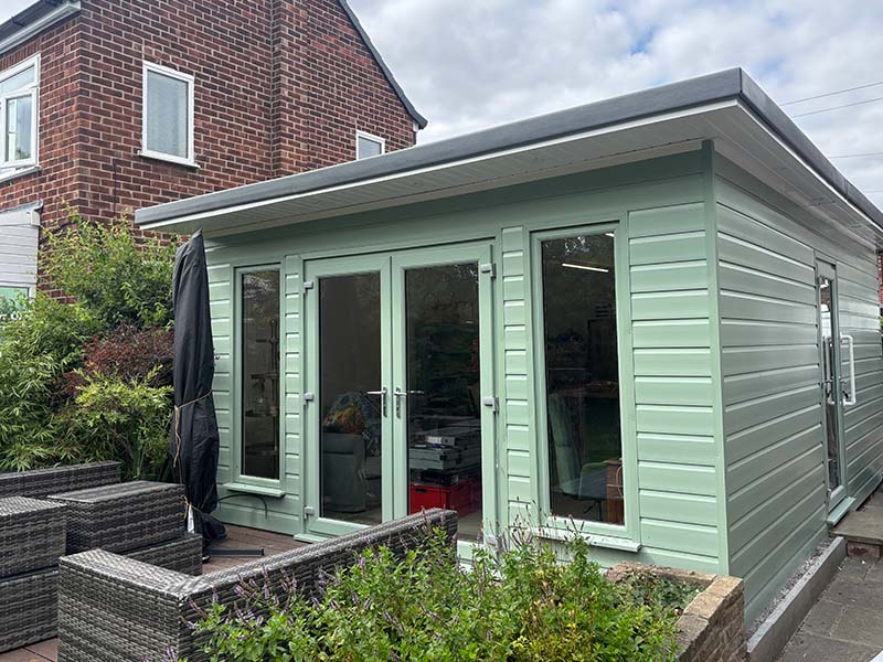 bespoke shipping container garden room blackpool in garden with decking